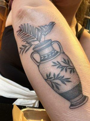 Vase tattoo on lower, right arm