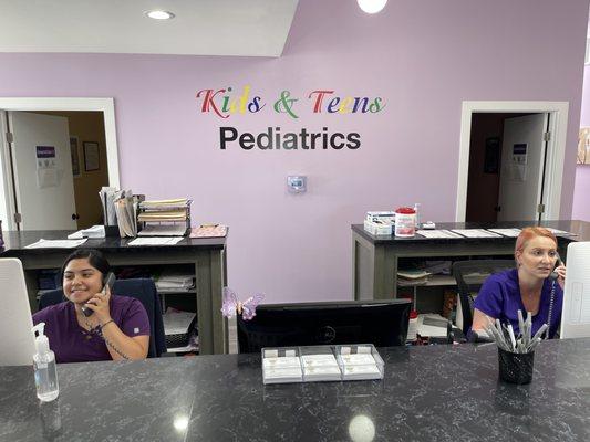 Natalie and Maggie helping parents on the phone