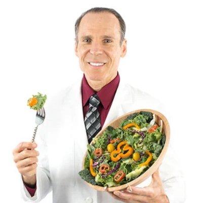 photo of Dr. Fuhrman holding a bowl of salad and a fork