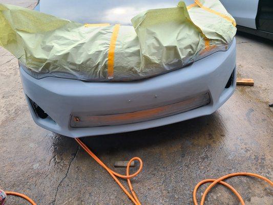 On this car, the bumper had paint peeling off, we had to
sand it, prime it, and finally, we painted the bumper.