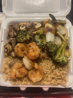 Steak & Shrimp Combo meal, comes with rice and zucchini and onions.