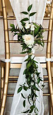 Roses on the chairs at the reception.