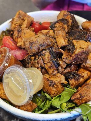 Chicken with greens, sweet potatoes, tomatoes and dressing.