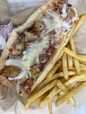 Chicken parm sub served with fries
