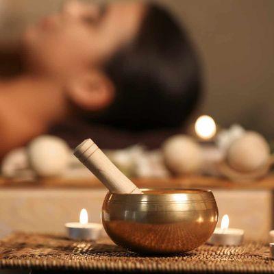 sound healing with singing bowl during massage treatment