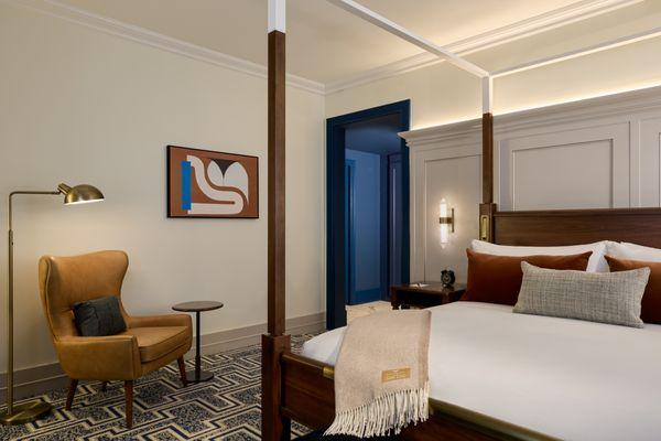 Experience luxury in our Corner Suite at The Dearborn Inn, featuring a spacious king bed for the ultimate comfort and relaxation during your