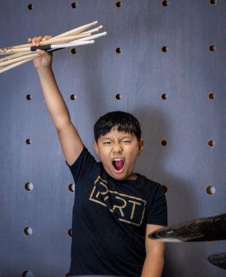 One of our awesome drum students excited to record a drum cover!