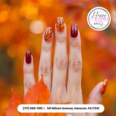 Red nails with delicate autumn leaves art -- a cozy, graceful look to complement your Thanksgiving moments. Treat yourself today!