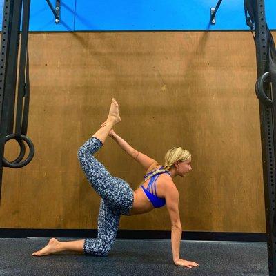 Our Yoga Instructor, Savannah, demonstrates a floor bow pose.