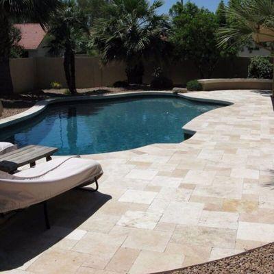 Travertine pool deck installed in a French pattern.