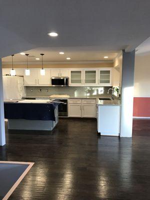 Quartz countertop with glass backsplash.