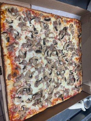 Thin square pizza with mushrooms