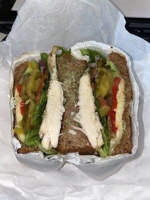 Full, Hot, Tuscan Chicken Sandwich, with lettuce, tomato, jalapeños, onion, banana peppers, pickles, roasted red peppers, and avocado.