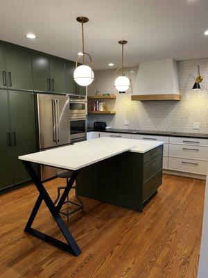 Kitchen island, cooktop, pantry wall.