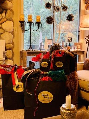 Wrapped gifts from Ranch Revived. Hyde Flasks, Leather Pillows, Candles, and more.