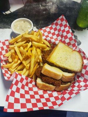 Chicken fried hamburger with fries and a side of country gravy