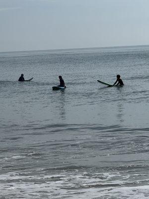 My son and instructor waiting for some waves.