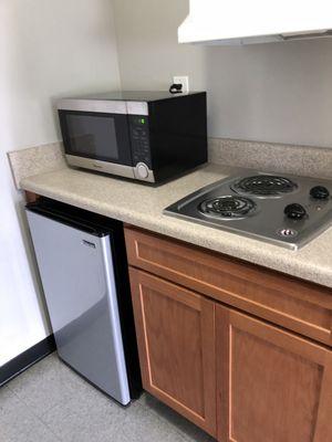 Kitchen includes a mini fridge, microwave and cooktop.