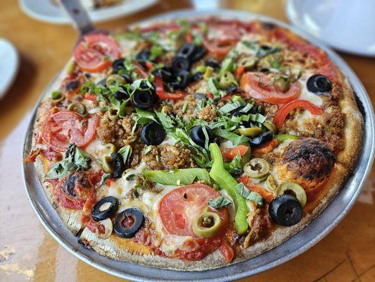 Napoletana pizza - sausage, peppers, olives, tomatoes, and basil
