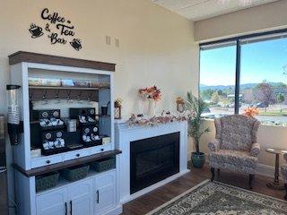 Warm and friendly waiting room with fireplace and coffee/tea bar. Includes a beautiful view of Pikes Peak