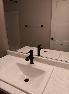 Nice and clean counter tops , mirror, and sink.