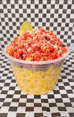 Elote Loco "Crazy Corn" Mexican street corn, topped with smoked brisket, Hot Cheeto dust & Parmesan cheese. Garnished with a lime wedge.