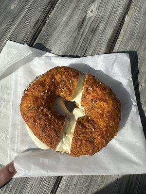 Cheddar everything bagel toasted with cream cheese
