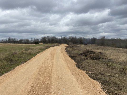 After road work. Cut organic material + top soil, drop and grade ~600 tons road base.