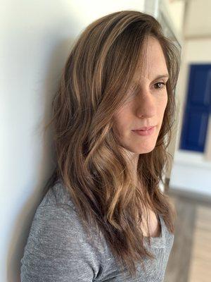 My client came in with previous highlights from another stylist. We decided to create a more blended look by toning the highlights down