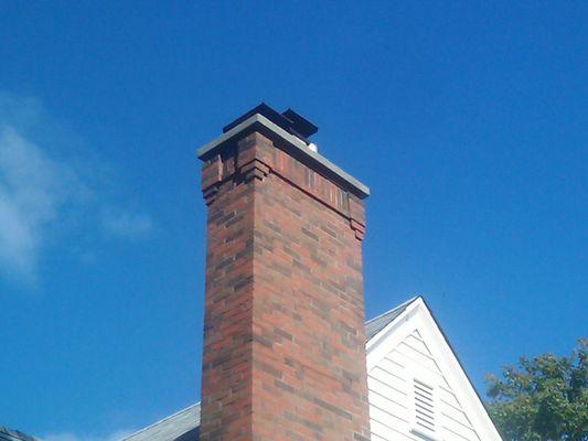 New chimney with decorative brick detail at the top.