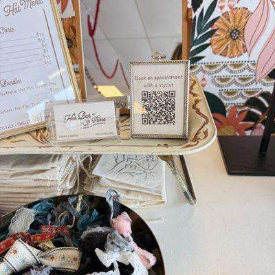 The custom hat QR code and contact info