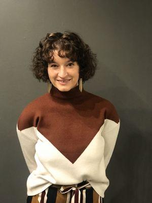 Naturally curly bob with bangs and subtle highlights to add dimension