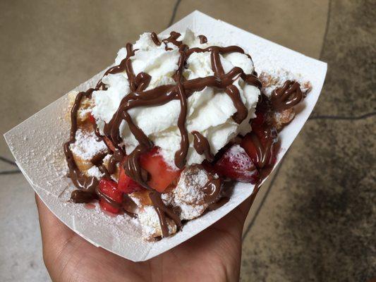 Belgian waffle with strawberry, whip cream, Nutella and powdered sugar