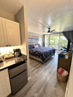 Studio Suite with a garden view, king sized bed, kitchenette with a microwave, mini fridge, coffee maker and kettle.