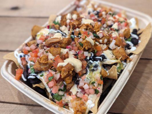 CHICKEN NACHOS nixtamal corn chips,black beans, house made queso, crema, salsa verde pico de gallo, guacamole (optional)