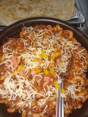 Oven Baked Goulash Supreme Seasoned freshly cooked ground beef sauteed with diced onions, peppers, celery, tossed in a Rouge Sauce and baked