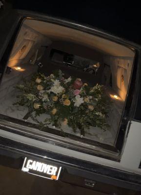 Hearse with casket flowers.
