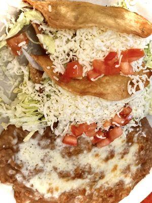 Hard-shell shredded beef tacos with delicious refried beans, classic and delicious.