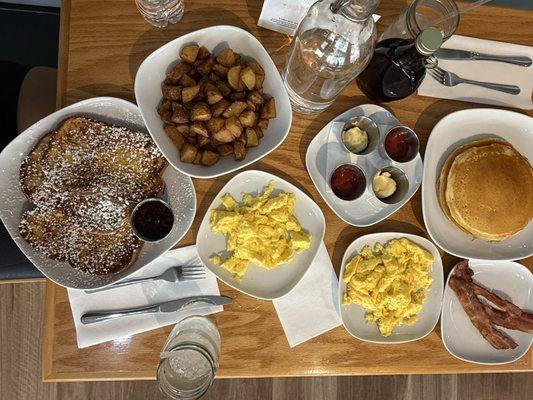 Eggs, bacon, French toast, pancakes and potatoes