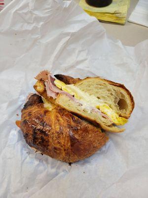 The breakfast sandwich. Ham, bacon, Eggs, and swiss cheese on a croissant. Outstanding