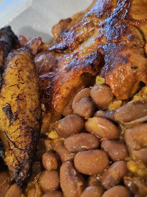 Close-up of Grilled Chicken with Yellow Rice and Red Beans and Sweet Plantains.