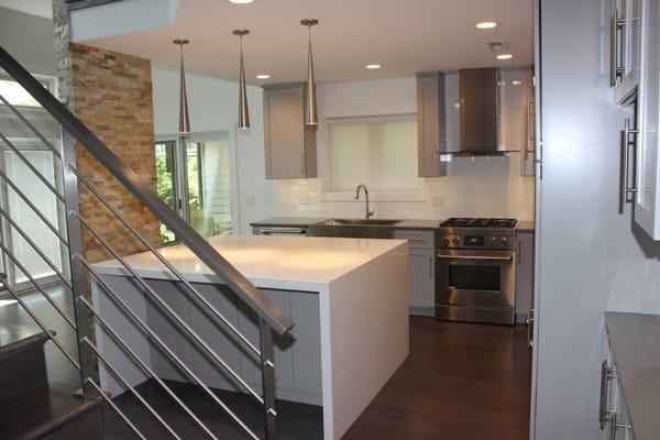 Kitchen blow up redesign!  Awesome contemporary railing with waterfall island! Room looks twice as large as original dated design!