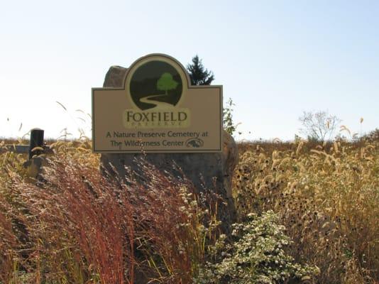 The simple, unobtrusive entrance to Foxfield Preserve surrounded by fall prairie grasses.