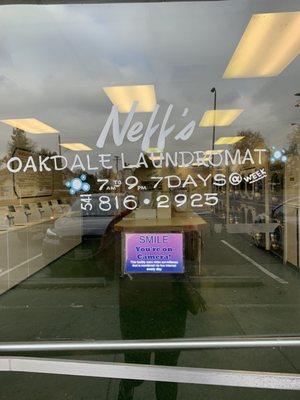 Front door with hours and phone number