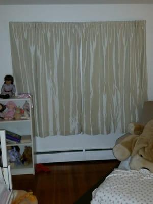 This bedroom's curtains were left hanging, and the screens were not uninstalled. Dirty red rag on the floor.