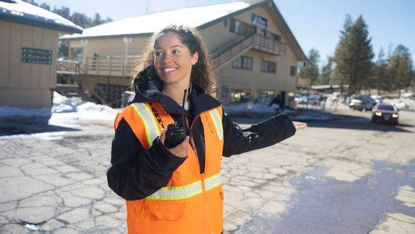 Snow Valley employee directing traffic.