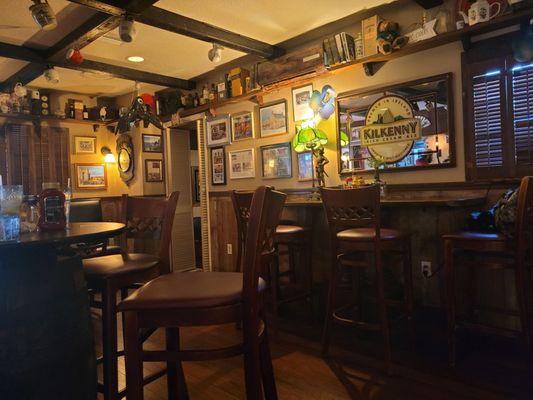 Walls adorned with pictures. Tables ready to seat patrons.