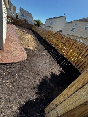 Grading with Topsoil supporting slope and French Drain