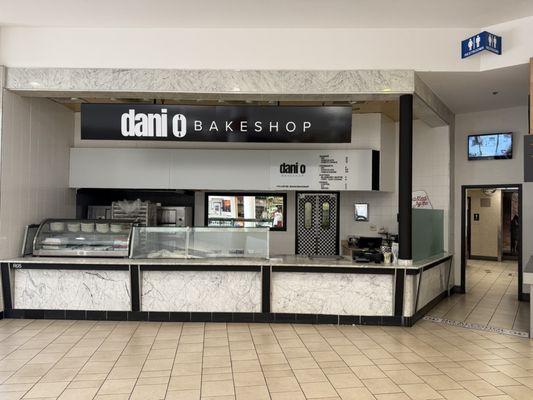 Right adjacent to the restrooms