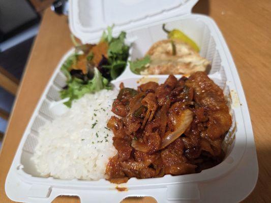 Spicy pork bulgogi with rice, salad and dumplings